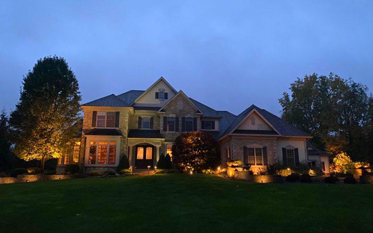 Home in the dark with decorative lighting and lawn