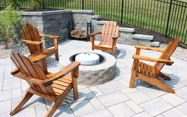 Firepit on a patio with chairs and retaining wall. Hardscape repair.