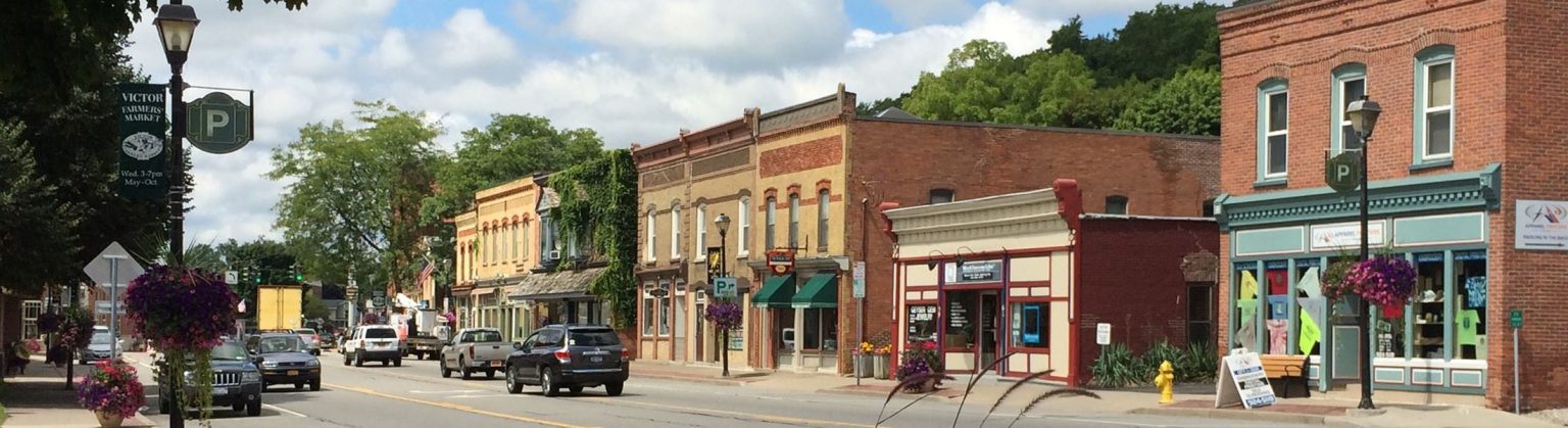 Charming downtown street in Victor, NY with historic shops.